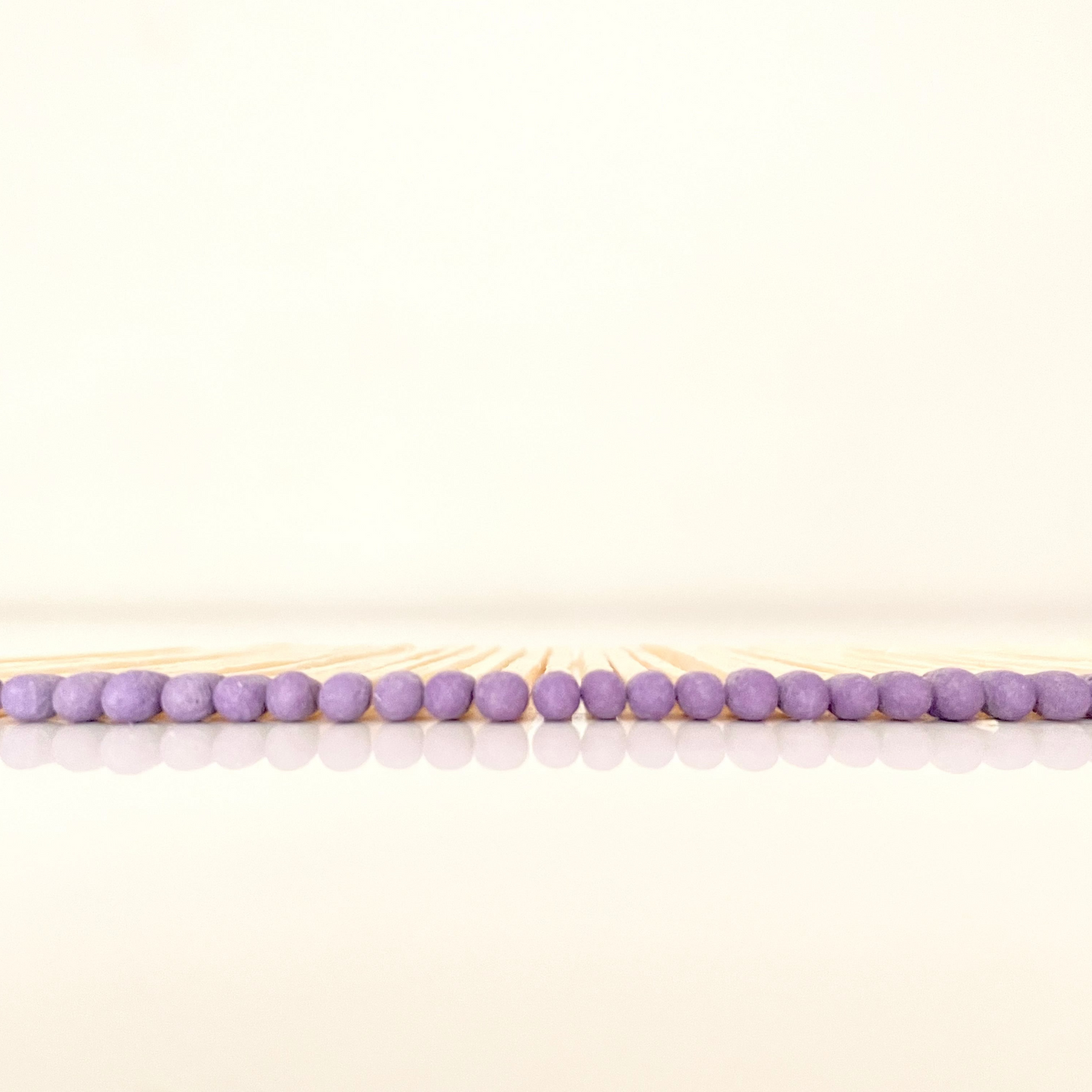 4.8 cm purple matches on a white surface. 