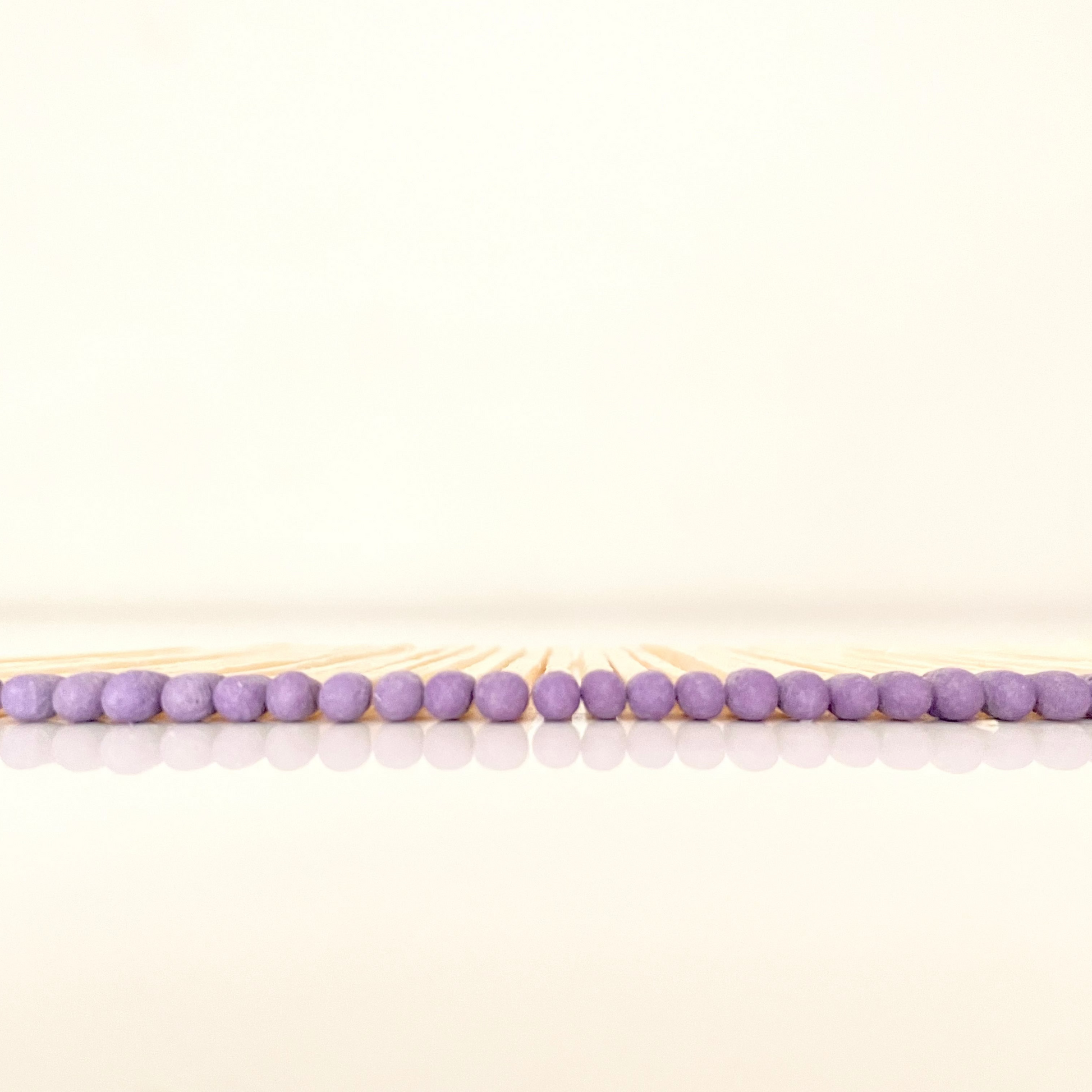 4.8 cm purple matches on a white surface. 