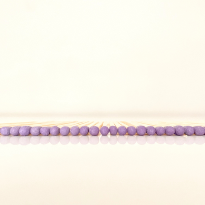 4.8 cm purple matches on a white surface. 