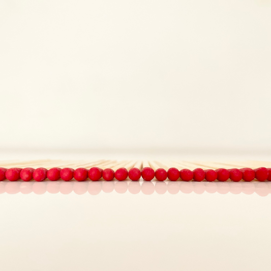 4.8 cm red matches on a white surface. 