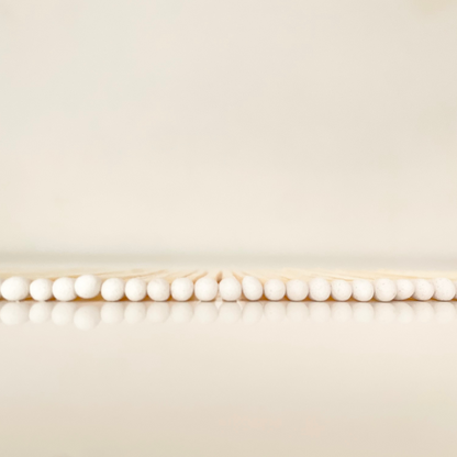 7.5 cm white matches on a white surface. 