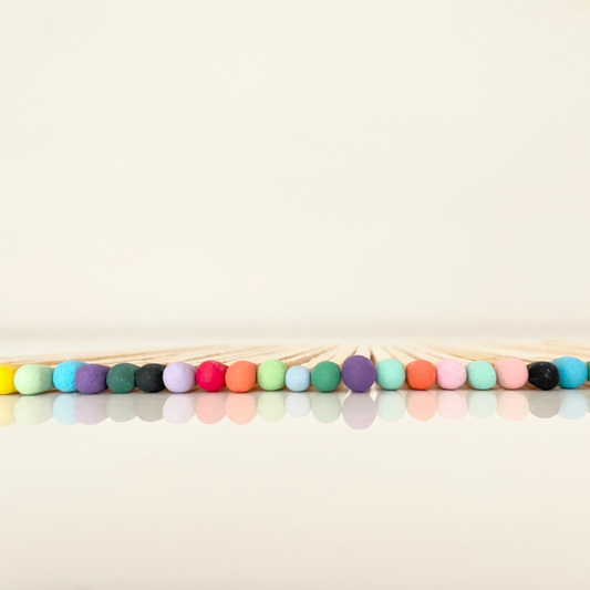 9.8 cm coloured matches on a white surface. 