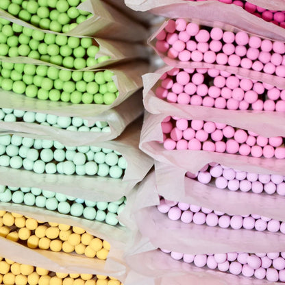 Rows of colourful 9.8 cm refill matches in recyclable wax paper. 