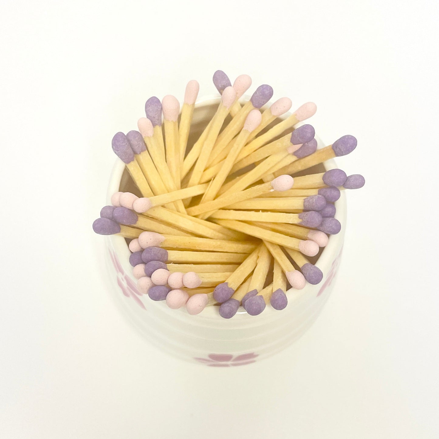 Refill Matches in a white ceramic mach holder with flowers. 