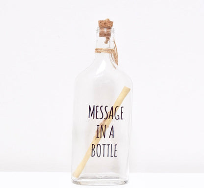 A glass bottle  with a message "MESSAGE IN A BOTTLE" and a cork lid, containing a scroll to write your personalised text.