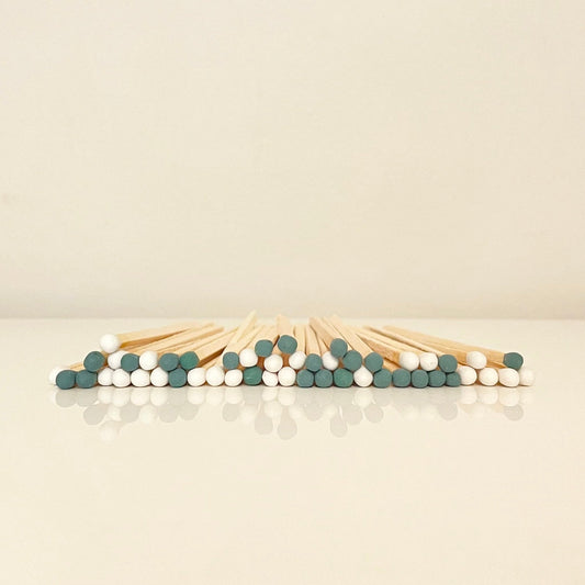 9.8 cm mistletoe matches on white surface.