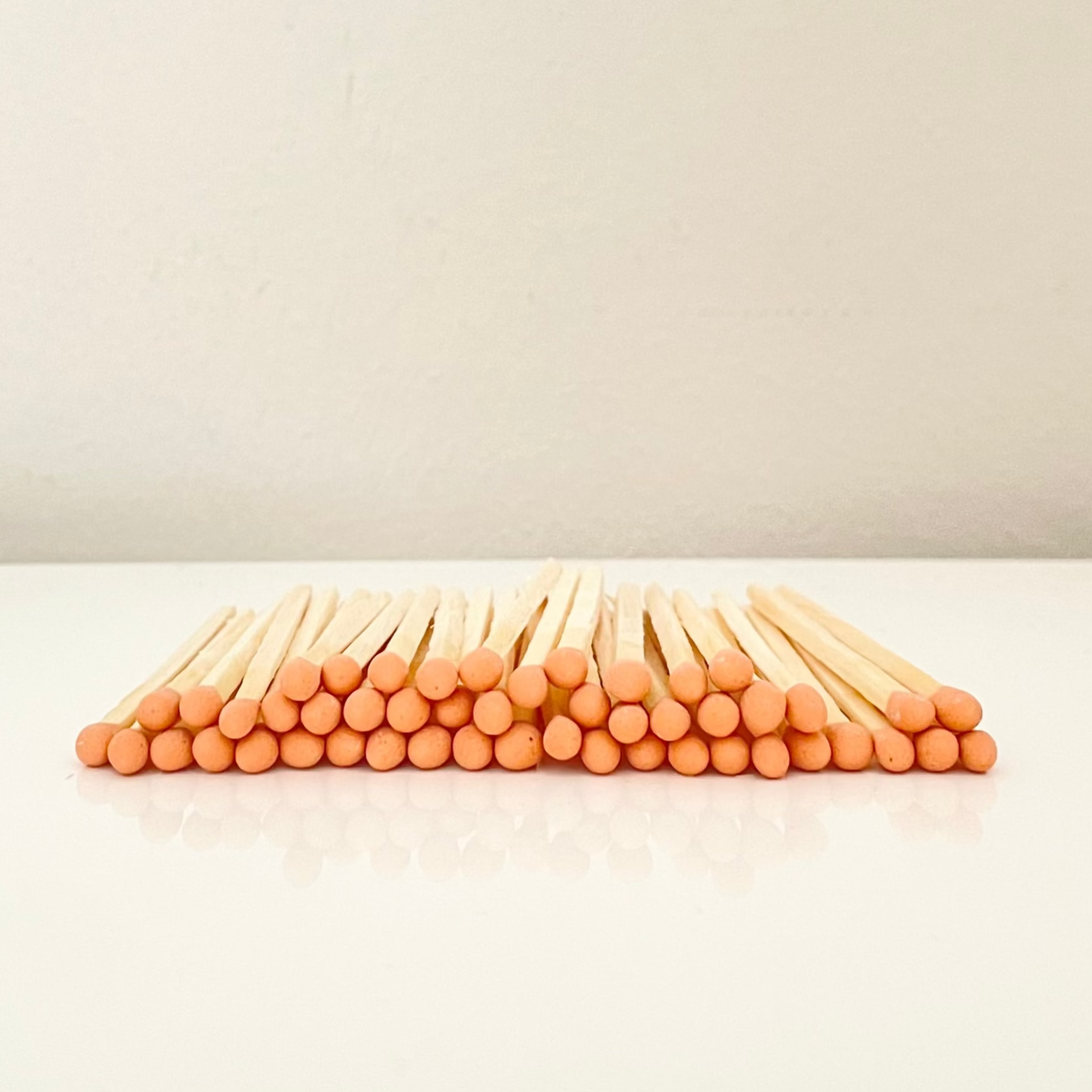 4.8 cm orange matches on a white surface. 