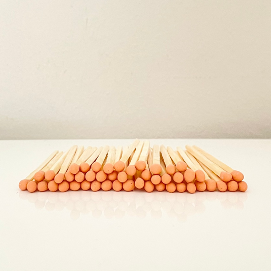 4.8 cm orange matches on a white surface. 