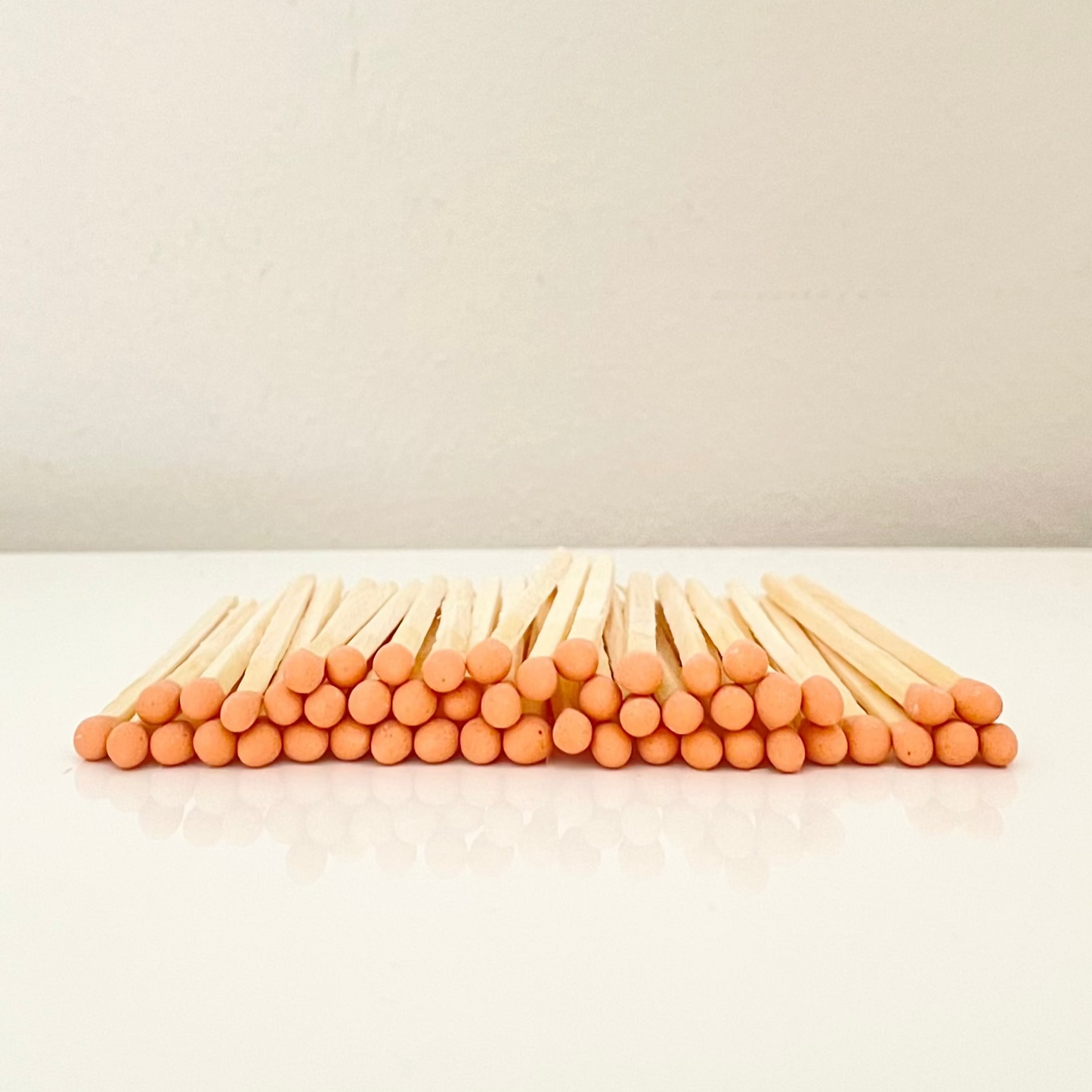7.5 cm orange safety matches on a white surface. 