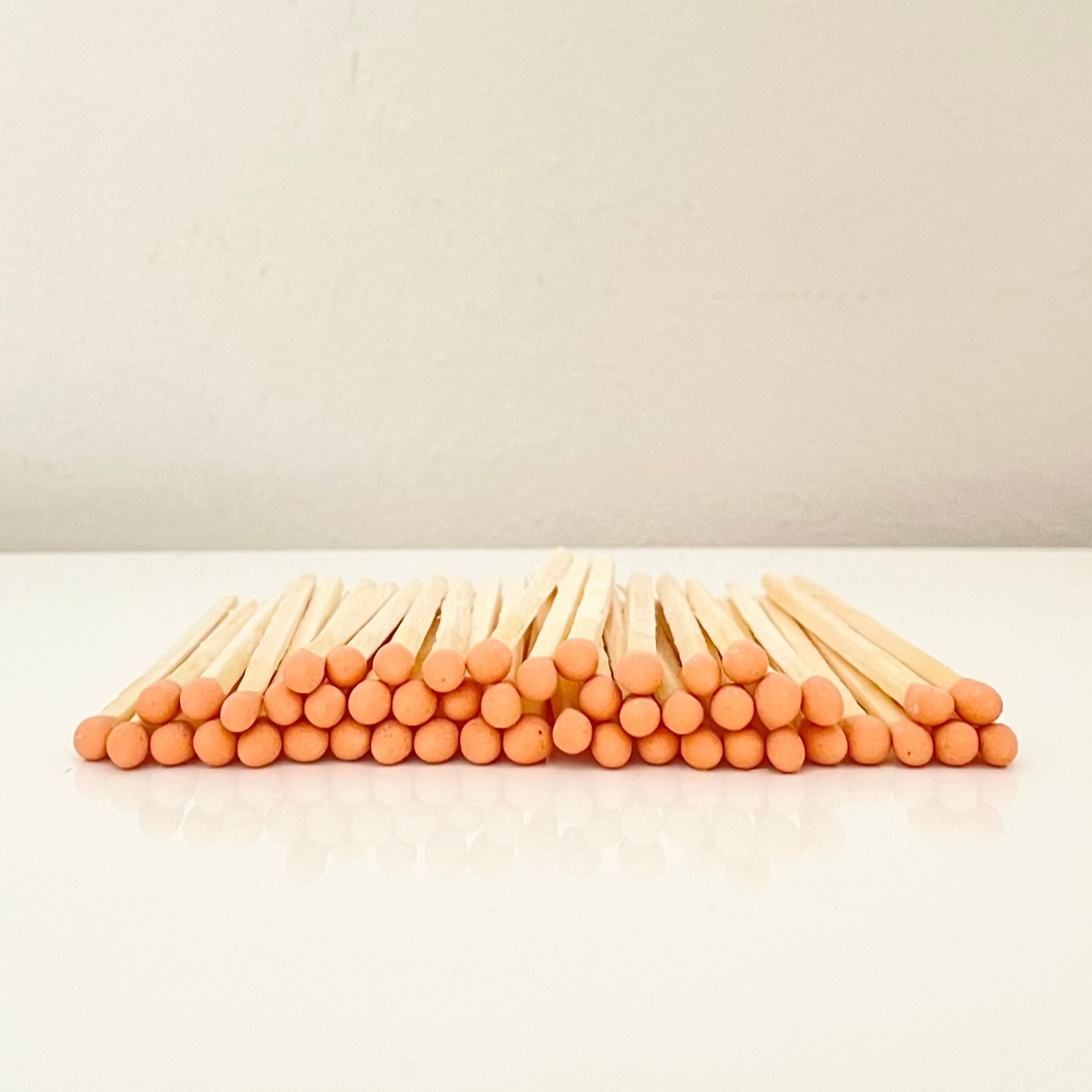 7.5 cm orange safety matches on a white surface. 