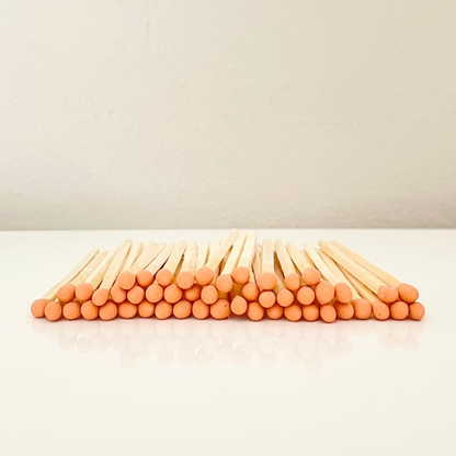 7.5 cm orange safety matches on a white surface. 