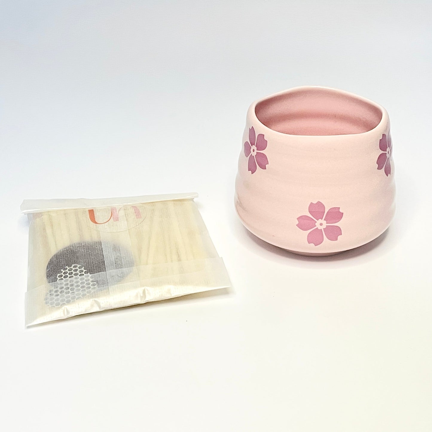 A gift set consisting of a pink match holder/coffee cup and 50 white and light pink 7.5cm matches.