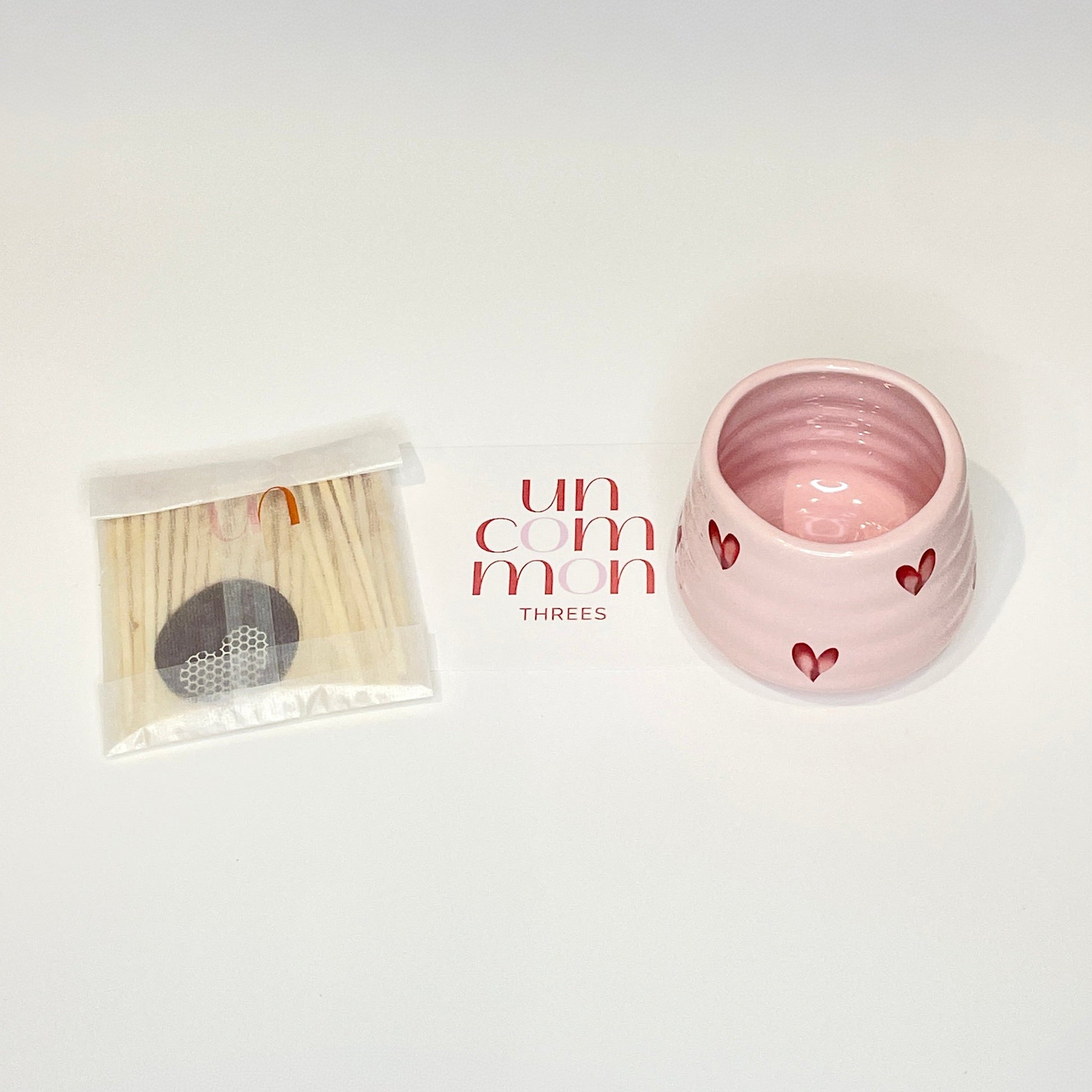 A gift set consisting of a pink match holder/coffee cup and 50 red and light pink 7.5cm matches.