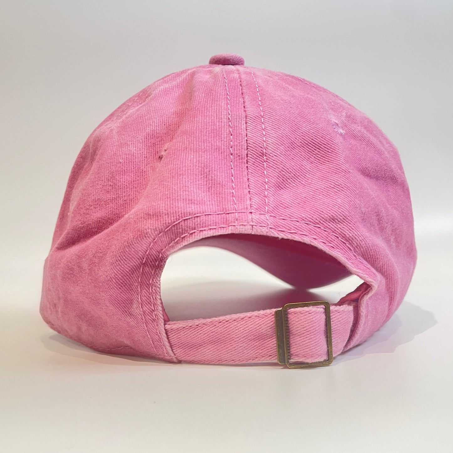 Pink cap with metal clasp on white background. 