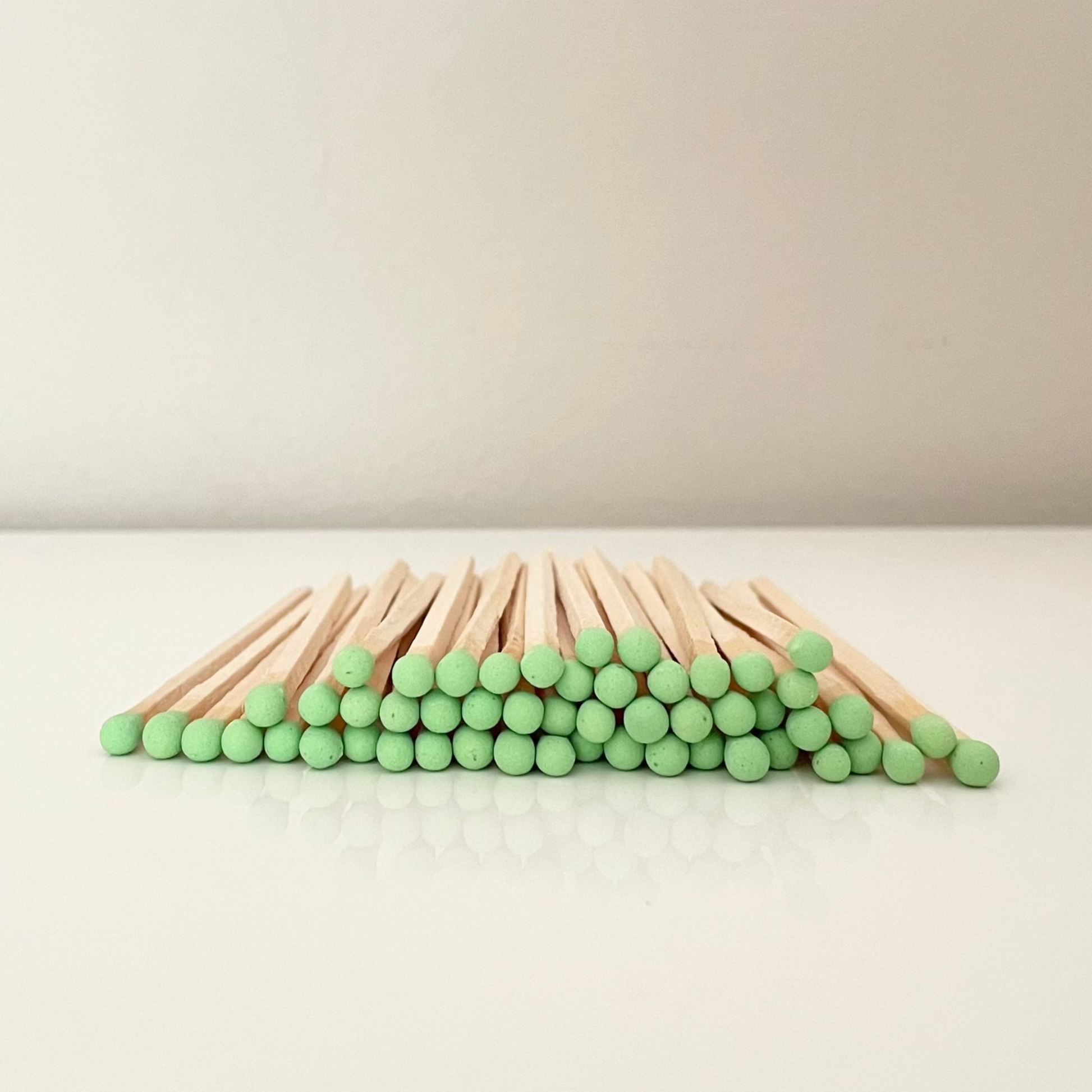 9.8 cm pistachio matches on surface.