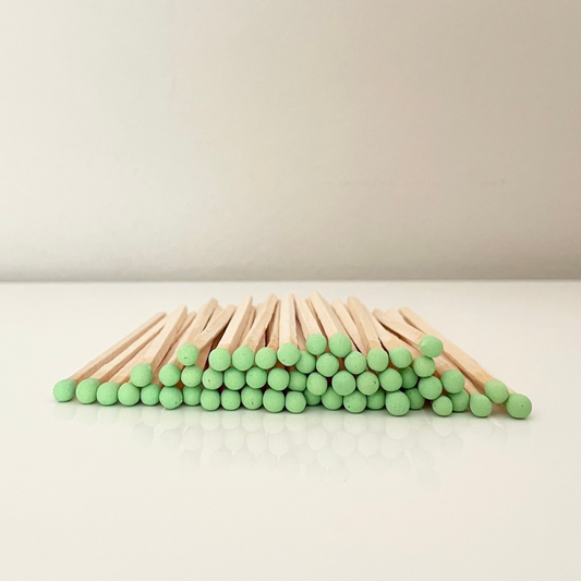 9.8 cm pistachio matches on surface.