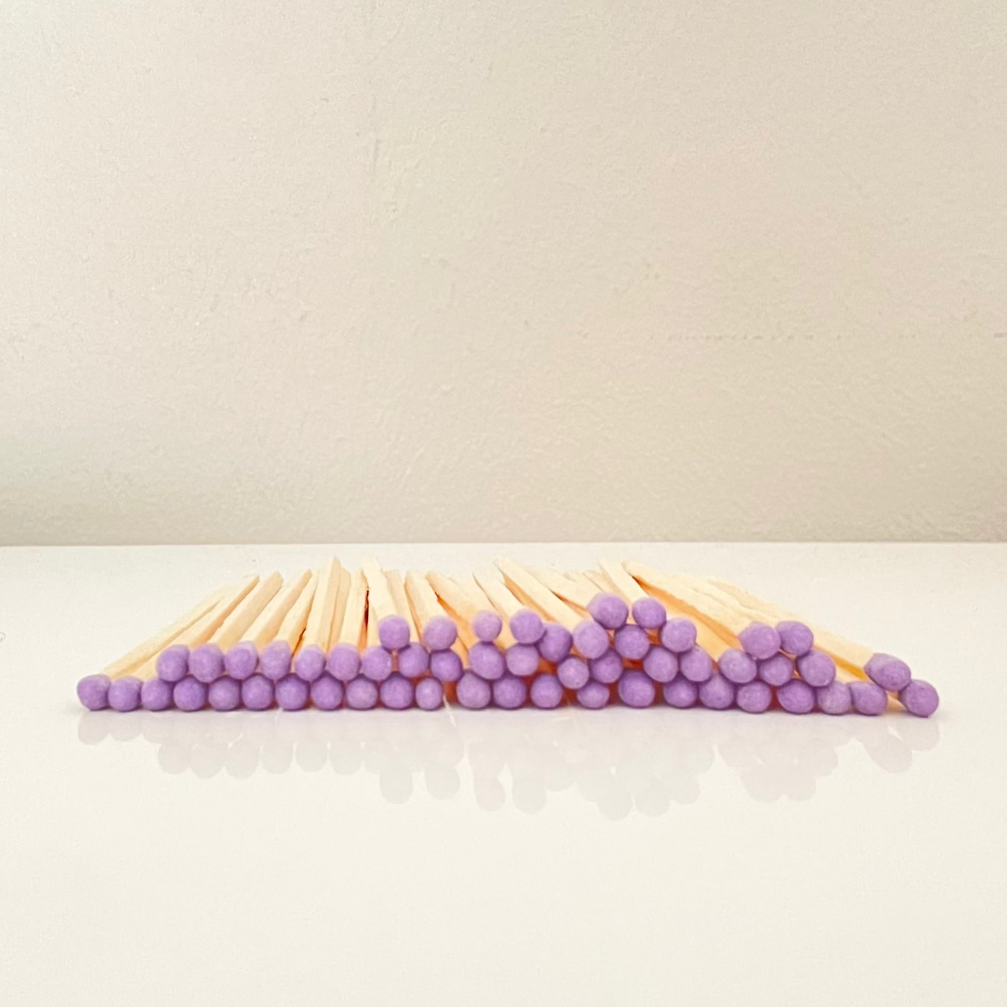 4.8 cm purple matches on a white surface. 