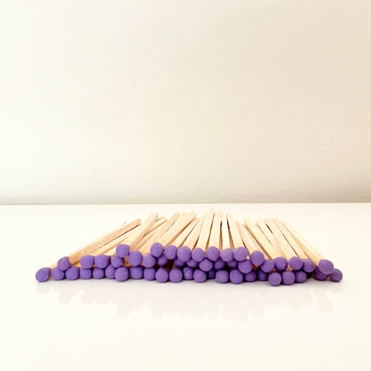 9.8 cm purple coloured matches on a white surface. 