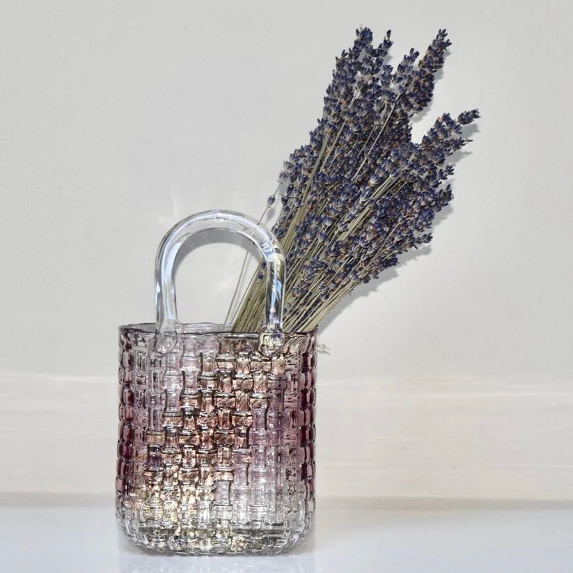 Decorative purple glass bag vase filled with dried  lavender. 