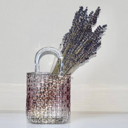 Decorative purple glass bag vase filled with dried  lavender. 