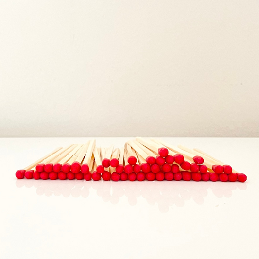 4.8 cm red matches on a white surface. 