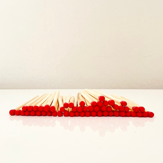 7.5 cm red matches on a white surface. 