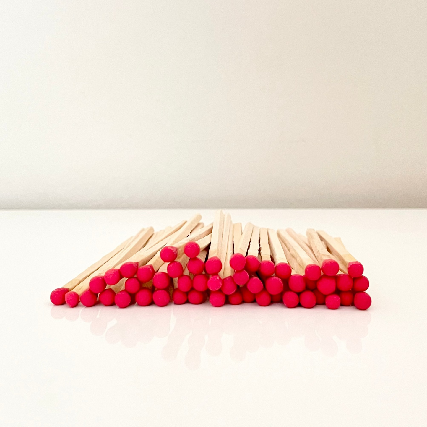 9.8 cm red matches on surface.