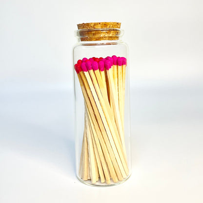 Test tube match bottle filled with 9.8 cm red and hot pink matches. 