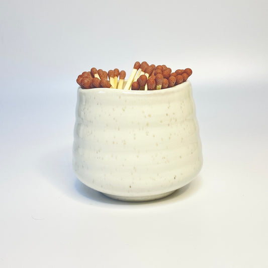 white sprinkled match holder with brown coloured safety matches.