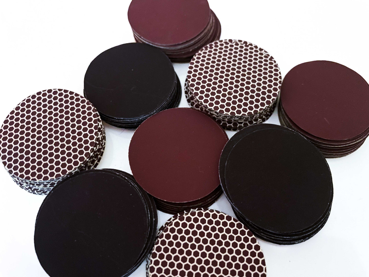 Stacked self adhesive match striker pads in black, brown, and honeycomb designs, 1.5" (3.8 cm) round, sold in bulk sets (12,24 or 50).