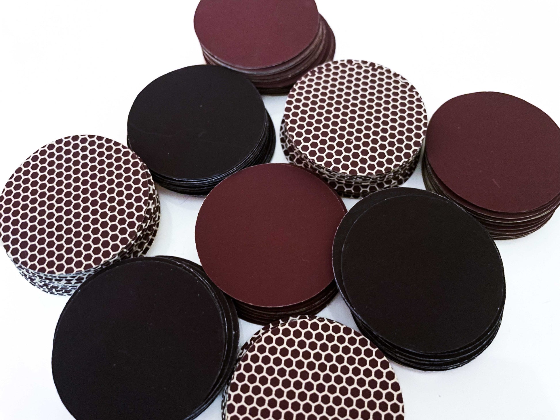 Stacked self adhesive match striker pads in black, brown, and honeycomb designs, 1.5" (3.8 cm) round, sold in bulk sets (12,24 or 50).