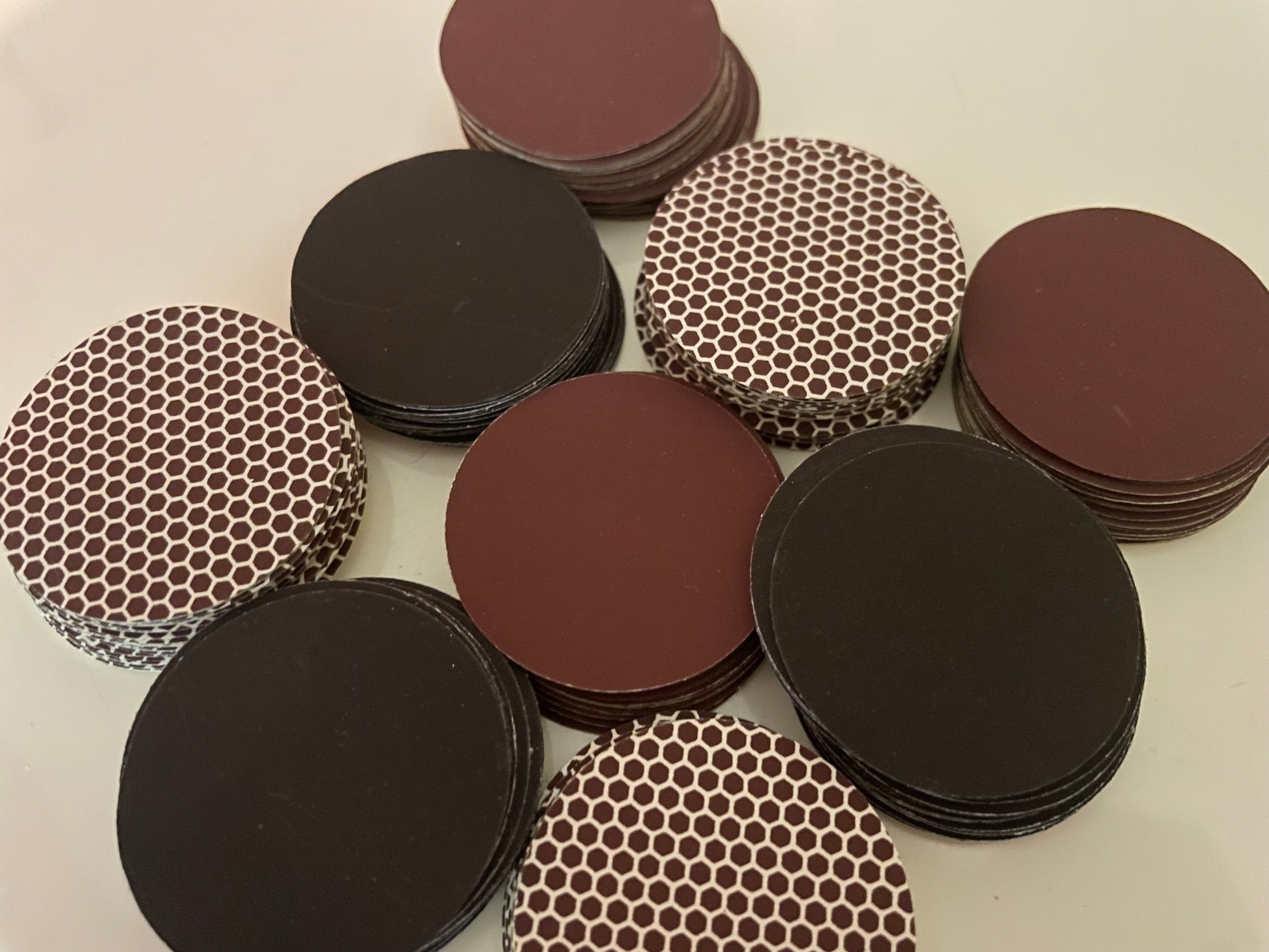 Stacked self adhesive match striker pads in black, brown, and honeycomb designs, 1.5" (3.8 cm) round, sold in bulk sets (12,24 or 50). 


