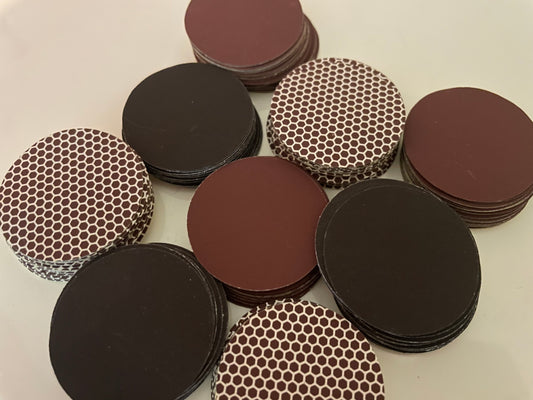 Stacked self adhesive match striker pads in black, brown, and honeycomb designs, 1.5" (3.8 cm) round, sold in bulk sets (12,24 or 50). 


