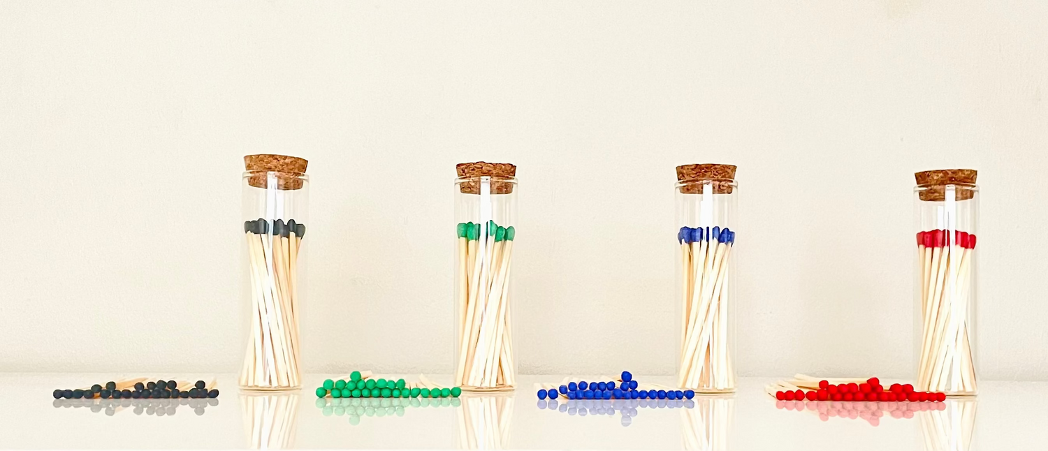 Aesthtic test tube match bottles filled with 25 7.5 cm colour tipped safety matches plus 25 loose refills on a white background.