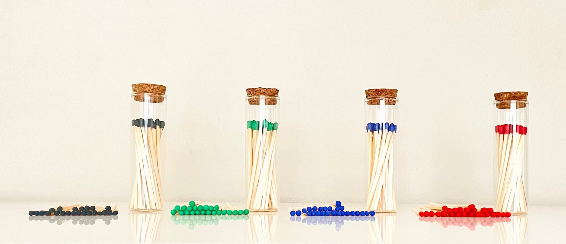Test tube match bottles filled with 25 7.5 cm colour tipped matches plus 25 loose refills on a white background.