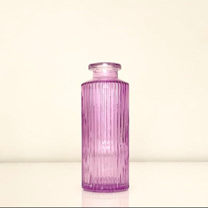 Textured purple glass vase on a white background.Perfect for displaying fresh or dried flowers, adding a minimalist yet elegant touch to your home decor.