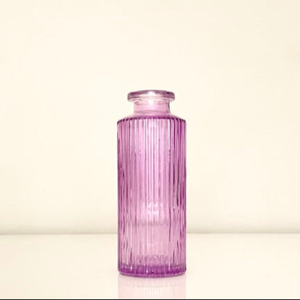 Textured purple glass vase on a white background.Perfect for displaying fresh or dried flowers, adding a minimalist yet elegant touch to your home decor.