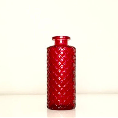 Textured red glass vase on a white background.Perfect for displaying fresh or dried flowers, adding a minimalist yet elegant touch to your home decor.