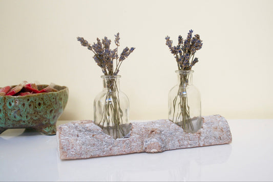 Tree Trunk Vase filled with lavender on a white surface. 