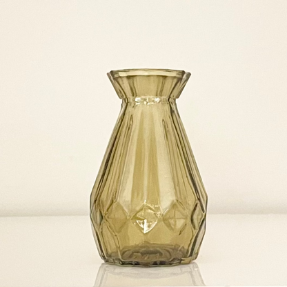 Amber glass vase (B) with textured surface on a white background.