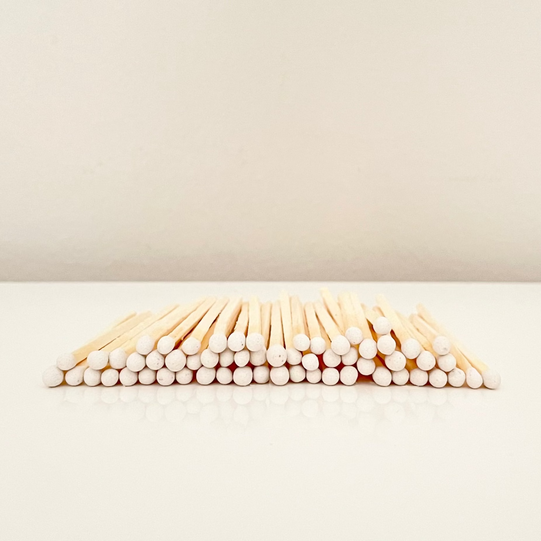 4.8 cm white matches on a white surface. 