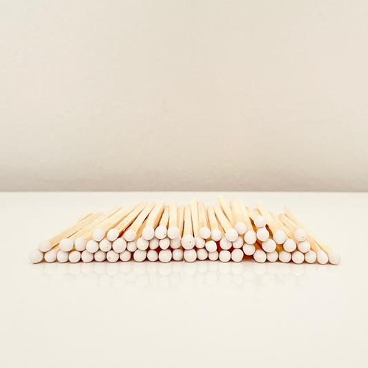 4.8 cm white matches on a white surface. 