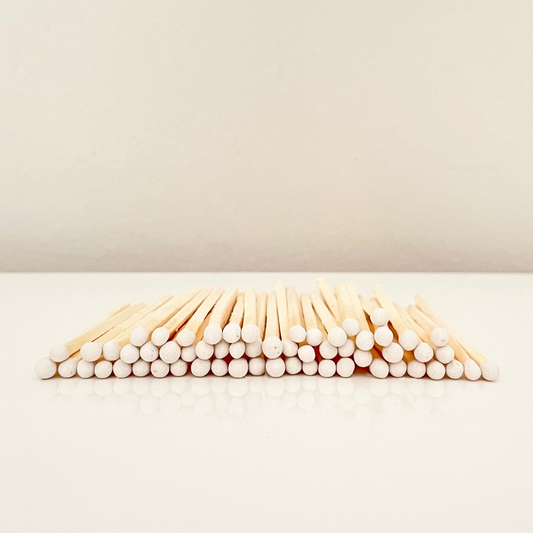 7.5 cm white matches on a white surface. 