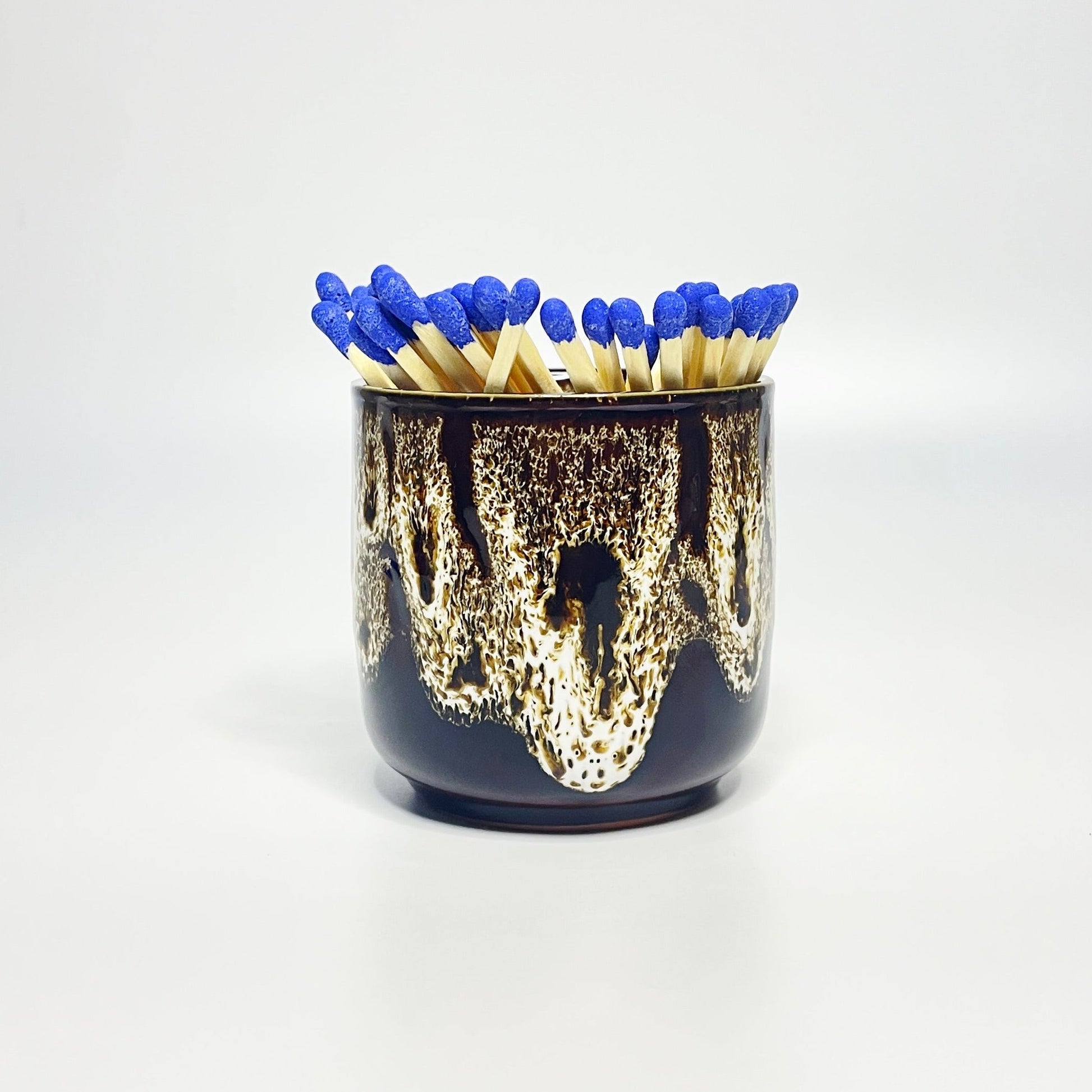 White glazed match holder filled with 7.5 cm refill matches (sold seperately) on white surface.