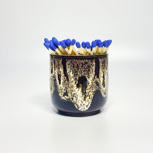 White glazed match holder filled with 7.5 cm refill matches (sold seperately) on white surface.