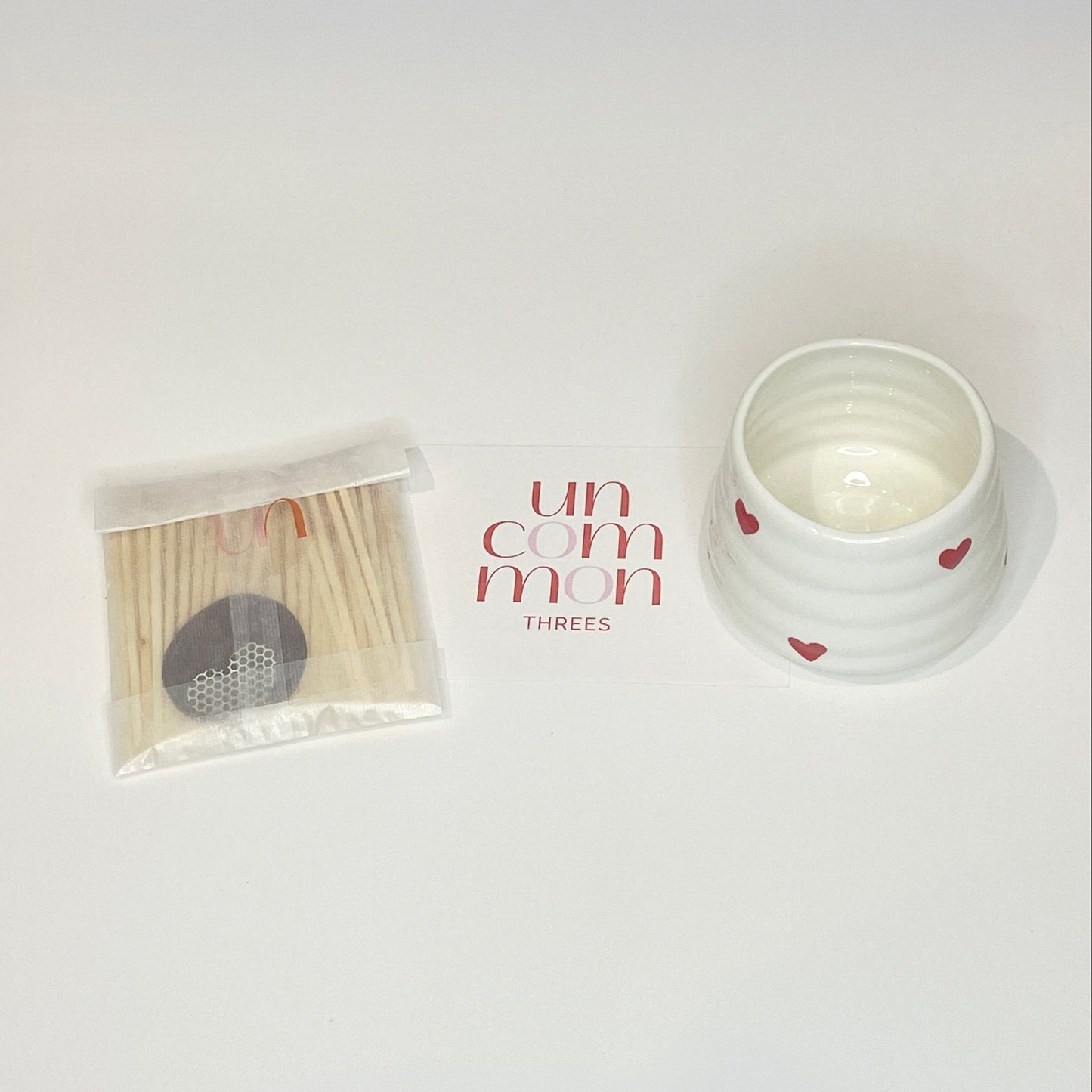 A gift set consisting of a white match holder/coffee cup and 50 red and white 7.5cm matches.
