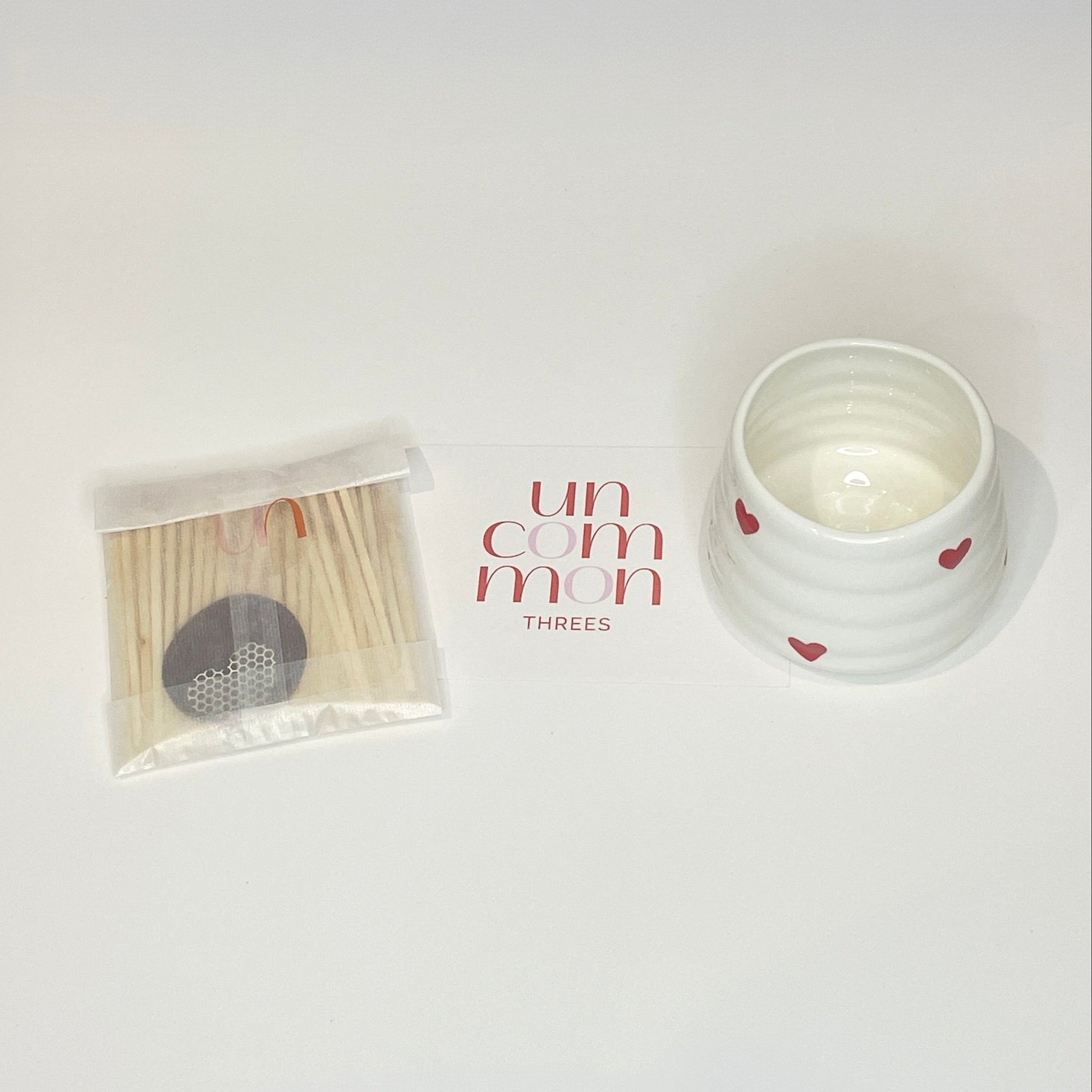 A gift set consisting of a white match holder/coffee cup and 50 red and white 7.5cm matches.