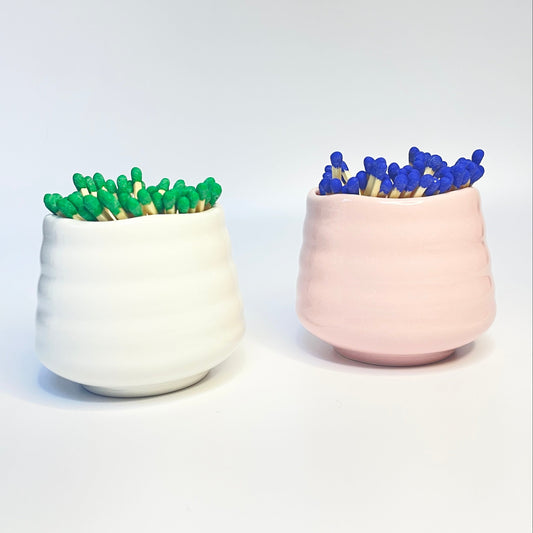 white and pink match holder/ coffee cups with green and blue coloured safety matches.