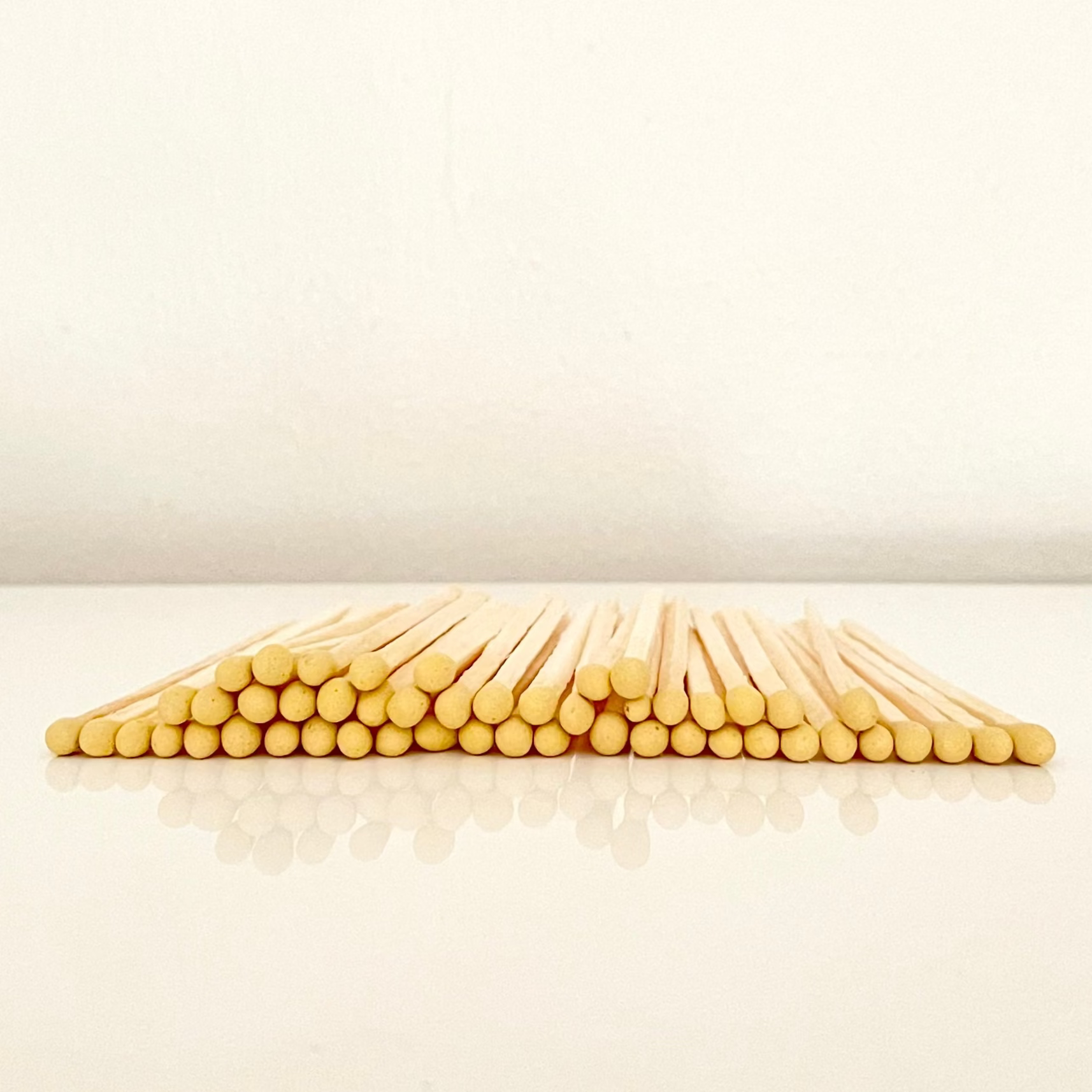 4.8 cm yellow matches on a white surface. 