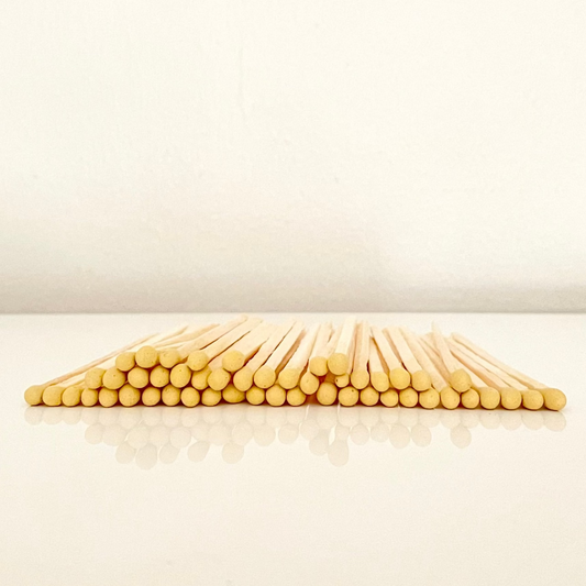 4.8 cm yellow matches on a white surface. 